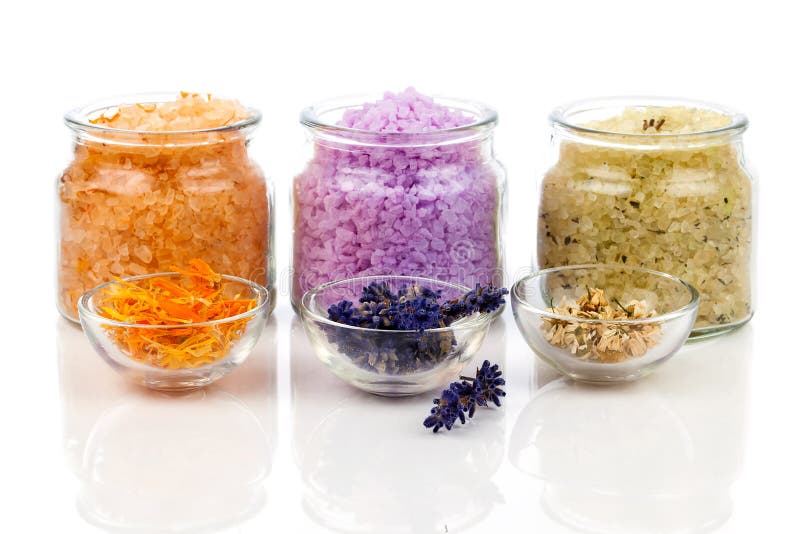 Various kinds of bath salt with flowers royalty free stock images
