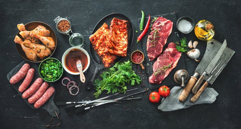 Various kinds of grill and bbq meats with vintage kitchen and butcher utensils. Chicken legs, steaks, sausages, pork ribs with herbs, spices, sauces and stock images Various kinds of grill and bbq meats with vintage kitchen and butcher utensils. Chicken legs, steaks, sausages, pork ribs with herbs, spices, sauces and stock images