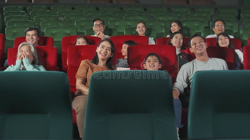 An Asian audience enjoys watching cinema together at movie theaters.