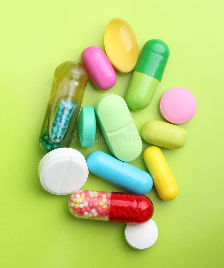 Various pharmaceuticals, pills on green background. Green herbal drug medicine stock images, royalty-free photos and pictures