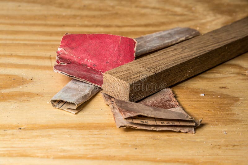 Various Sandpaper and Oak Wood on Pine Workbench Endgrain Stock Image