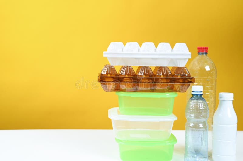 Various Types of Plastic Packaging on a Yellow Background. Recycling