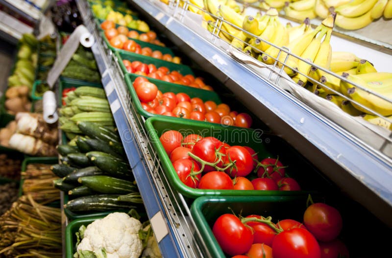 Various vegetables and fruits on display in supermarket royalty free stock photos