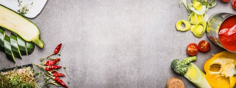 Various vegetables for testy vegan or vegetarian cooking on gray concrete background, top view