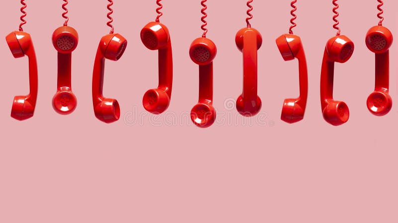 Various views of old red telephone receivers hanging on pink background.