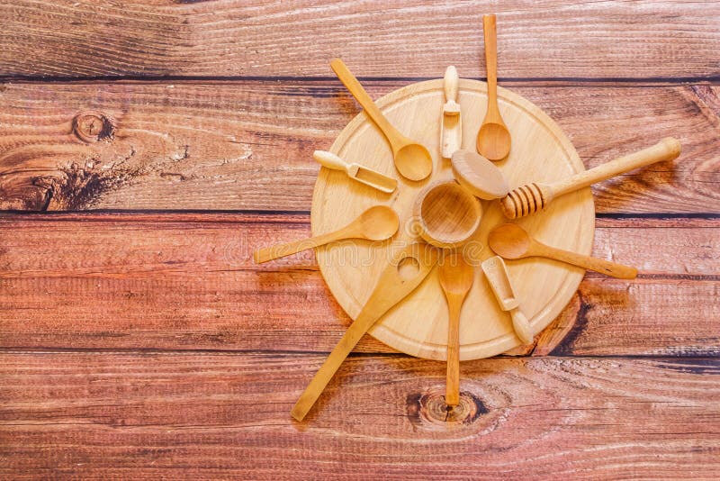 Various Wooden Kitchen Utensils on Wooden Plate on Wooden Table Stock