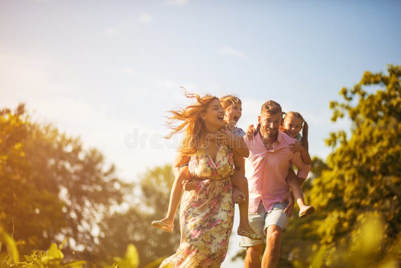 Every moment spent together is absolute bliss. Parents with daughters in nature. Every moment spent together is absolute bliss. Parents with daughters in nature