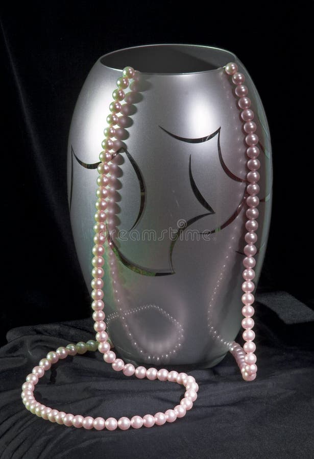 Vase with beads at black stock image. Image of beam, life 285569