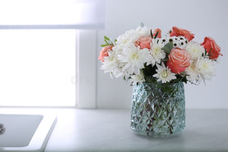 Vase with Beautiful Flowers on Countertop in Kitchen, Space for Text