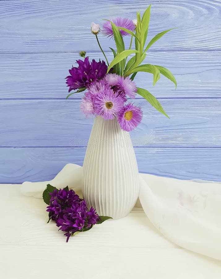 Vase flowers bell, purple elegance beauty spring chrysanthemum arrangement on a wooden background