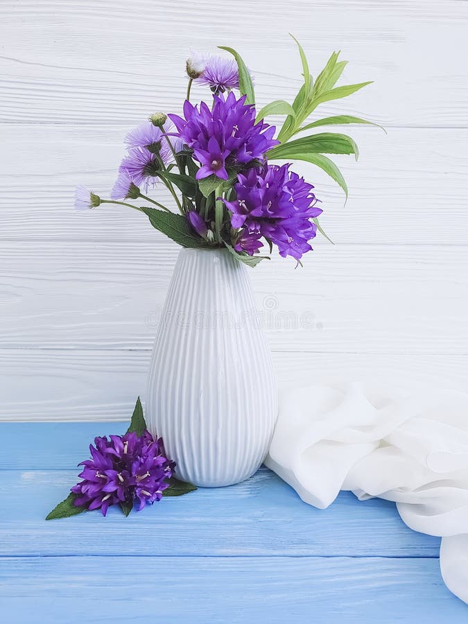 Vase flowers bouquet bell, purple card minimalism beauty spring on a wooden background