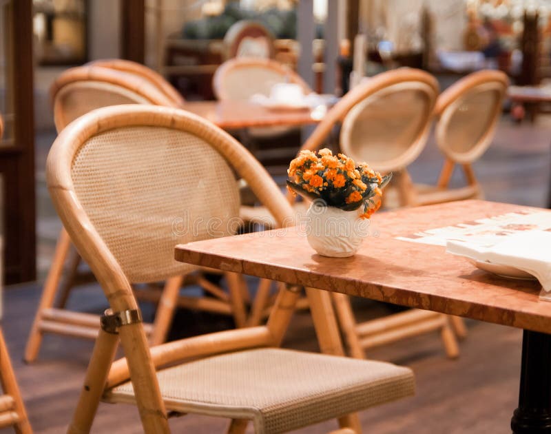 Vase with flowers on the table in cafe