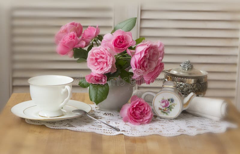 Vase of roses and cup of tea