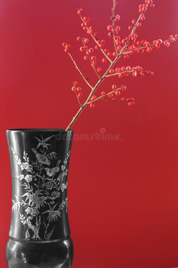 Vaso exótico com bagas vermelhas