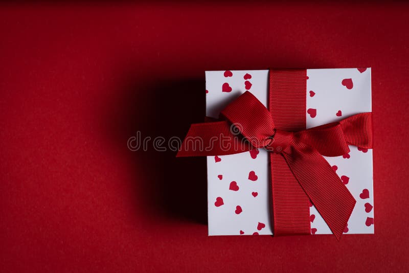 Vatentine`s day concept - present on red background stock photography