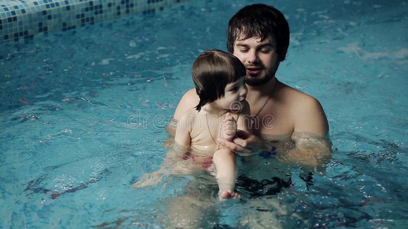 Vater und Sohn im Pool Junger Vati unterrichtet seinen 3-jährigen Sohn zu schwimmen