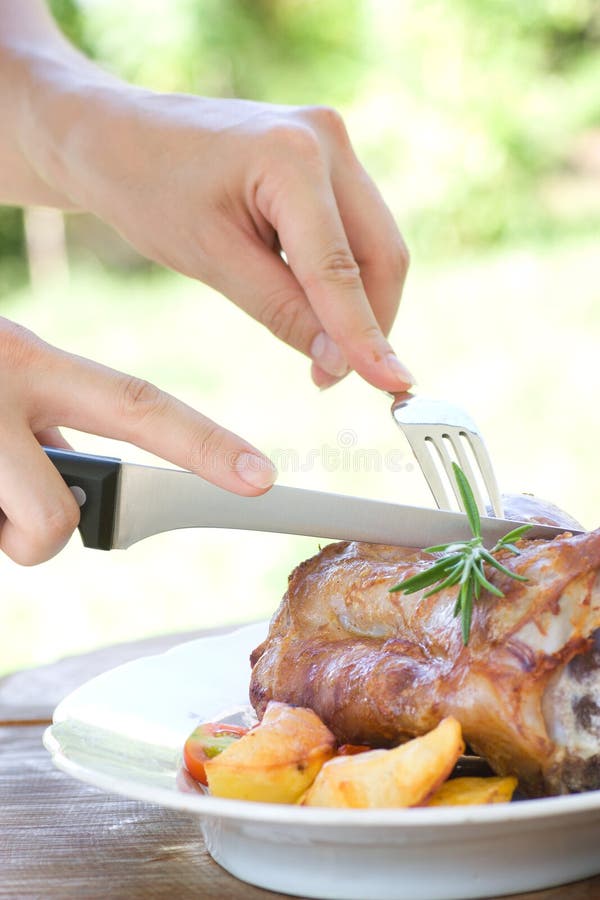 Veal knuckle with potatoes stock photo. Image of knife 21712406