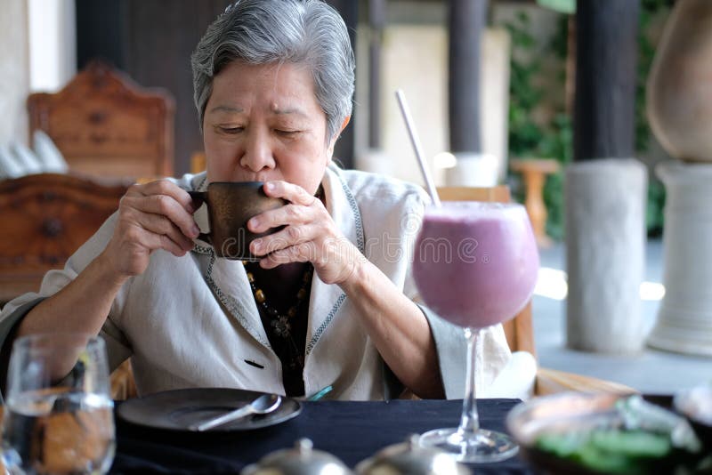 Old elderly senior elder woman drinking coffee tea at restaurant. mature retirement lifestyle. Old elderly senior elder woman drinking coffee tea at restaurant. mature retirement lifestyle