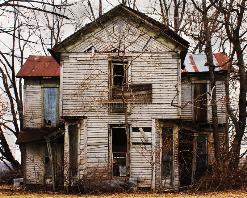 Dilapidated abandoned spooky house with a tin roof and rotting wooden boards. Dilapidated abandoned spooky house with a tin roof and rotting wooden boards.