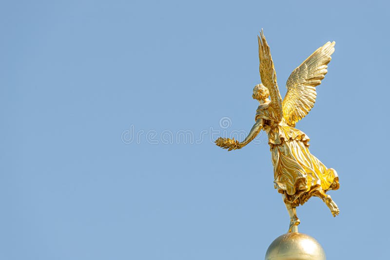 Vecchia statua di un angelo d'oro come guerriero e difensore nella cupola in cima all'edificio storico centrale del museo dell'Al fotografia stock libera da diritti Vecchia statua di un angelo d'oro come guerriero e difensore nella cupola in cima all'edificio storico centrale del museo dell'Al fotografia stock libera da diritti
