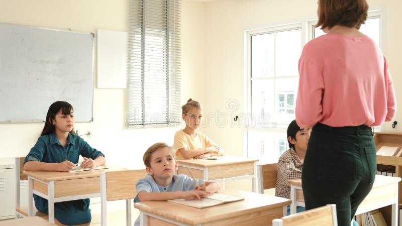 Vedere din spate a profesorului caucazian preda diverse student la tablă. Pedagogie. stock image