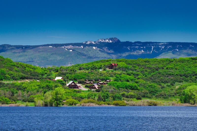 Late June Snow Above Colorado Lake. Vega State Park near Collbran Colorado is a popular destination for outdoor sports. Not far from Grand Mesa National Forest royalty free stock photography Late June Snow Above Colorado Lake. Vega State Park near Collbran Colorado is a popular destination for outdoor sports. Not far from Grand Mesa National Forest royalty free stock photography
