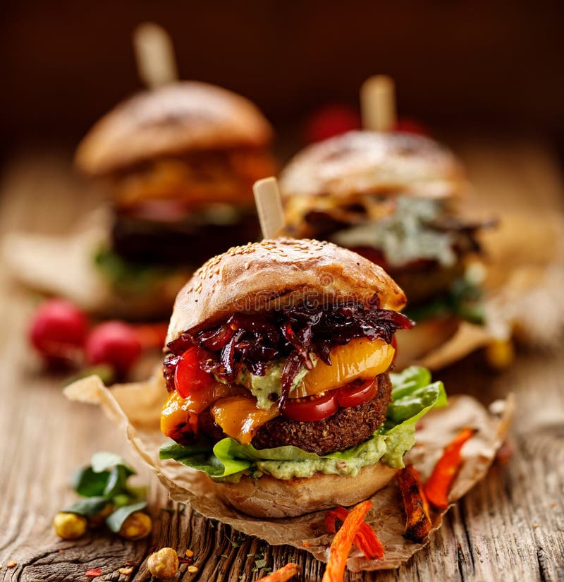 Vegan burger, carrot burger, homemade burger with carrot cutlet, grilled bell pepper, cherry tomatoes, red onion chutney, lettuce, stock image Vegan burger, carrot burger, homemade burger with carrot cutlet, grilled bell pepper, cherry tomatoes, red onion chutney, lettuce, stock image