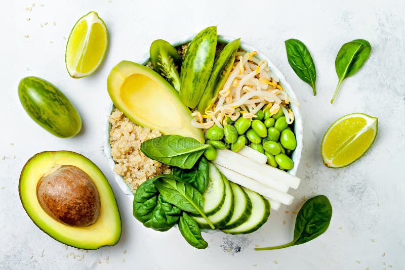 Vegan, detox green Buddha bowl recipe with quinoa, cucumber, broccoli, asparagus and sweet peas.