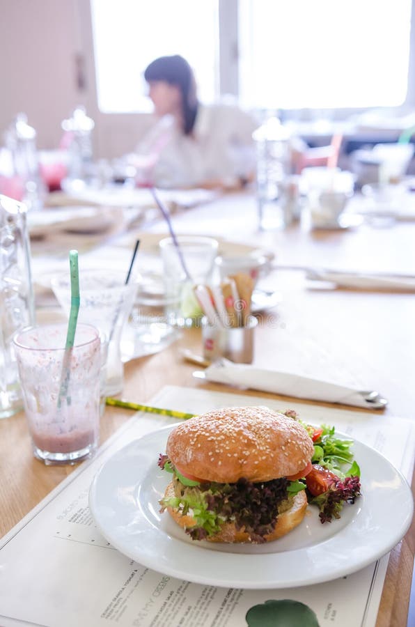 Vegan quinoa burger in a restaurant stock image Vegan quinoa burger in a restaurant stock image