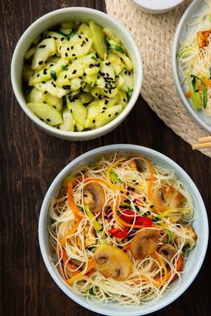 Vegan Rice Noodles With Tofu Peppers Carrots On Dark Brown Background Vegan Rice Noodles With Tofu Peppers Carrots On Dark Brown Background