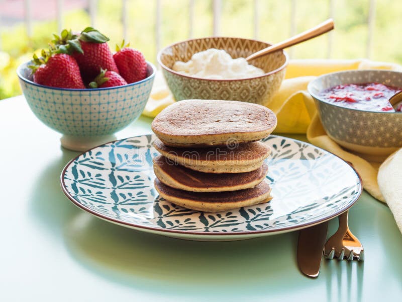 Vegan gluten free banana buckwheat pancakes served with dairy free yogurt and chia strawberry jam