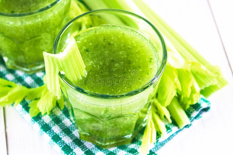 Vegetable cocktail made from celery leaves, healthy lifestyle on a white wooden background. Vegetable cocktail made from celery leaves, healthy lifestyle on a royalty free stock photos Vegetable cocktail made from celery leaves, healthy lifestyle on a white wooden background. Vegetable cocktail made from celery leaves, healthy lifestyle on a royalty free stock photos