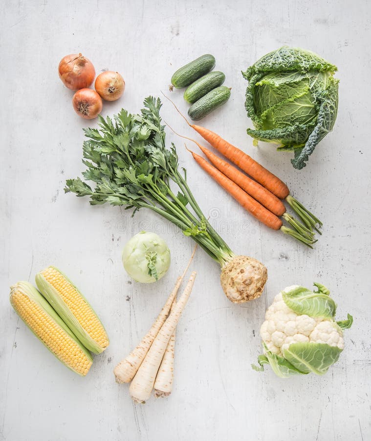 Vegetable. Fresh vegetable celery carrot onion parsnips cucumber kale cabbage kohlrabi and cauliflower on concrete background.