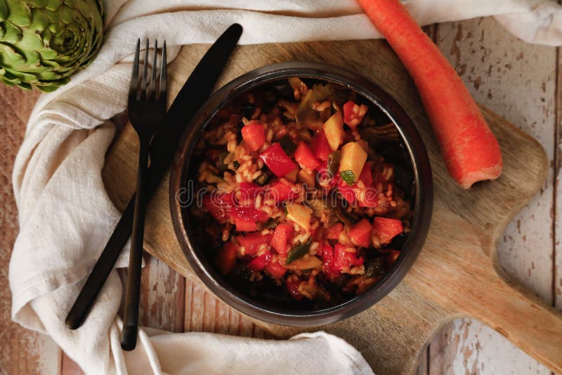 Vegetable rice with beans, zucchini, carrot, red pepper and artichokes. Typical Mediterranean food