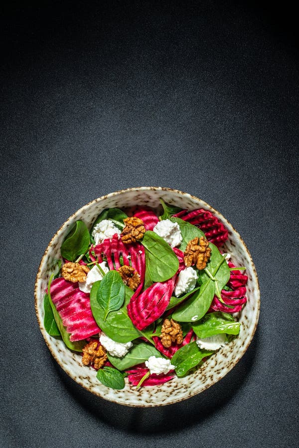 Vegetable Salad of Beet, Baby Spinach, Nuts and Cheese. Vertical Image