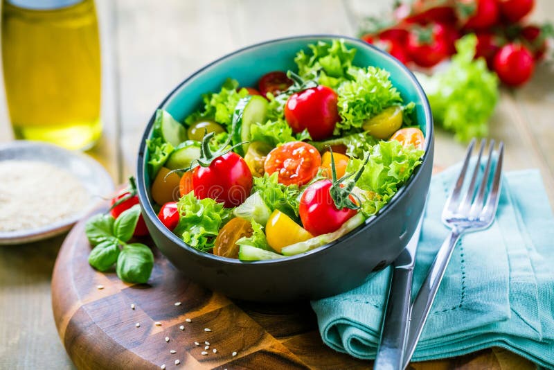 Vegetable Salad Bowl on Kitchen Table. Balanced Diet Stock Photo