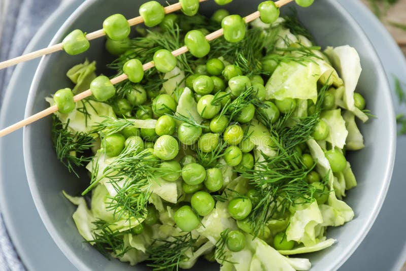 Vegetable Salad with Fresh Green Peas in Bowl, Closeup Stock Photo