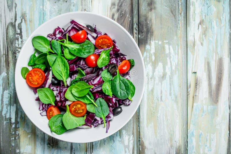 Vegetable Salad. Red Cabbage, Tomato and Spinach Salad with Olive Oil