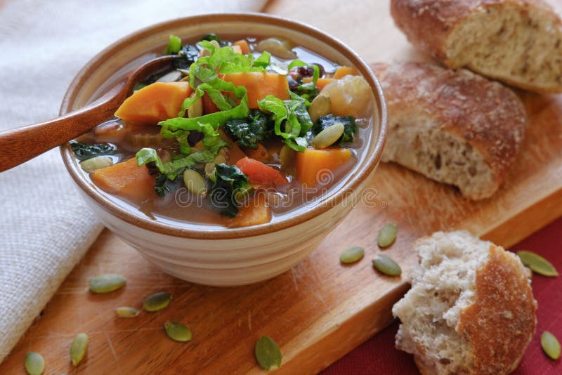 Vegetable soup in ceramic bowl with bread