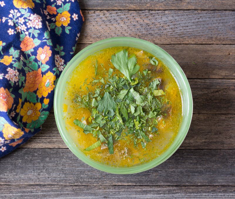 Vegetable Soup with Herbs on an Old Wooden Table Closeup Stock Image