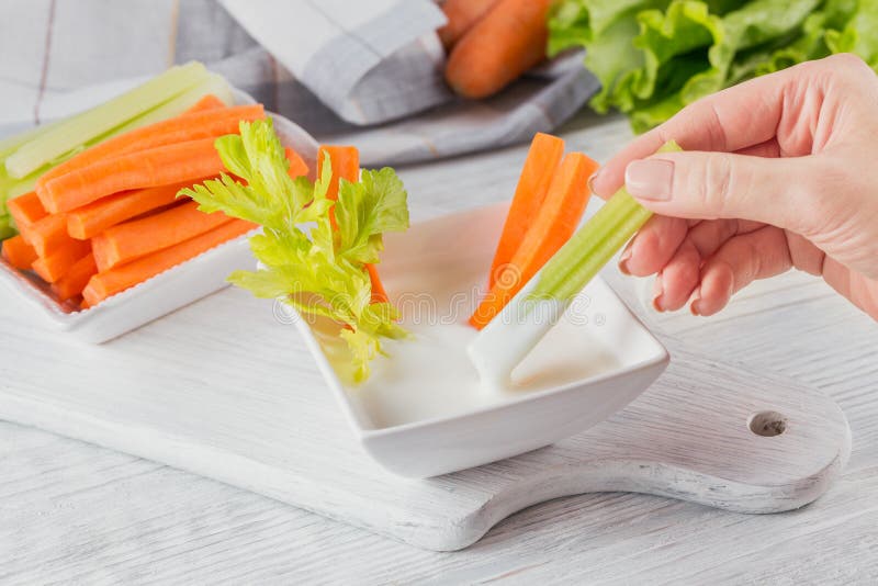 Vegetable sticks. Fresh celery and carrot with yogurt sauce. Healthy and diet food concept