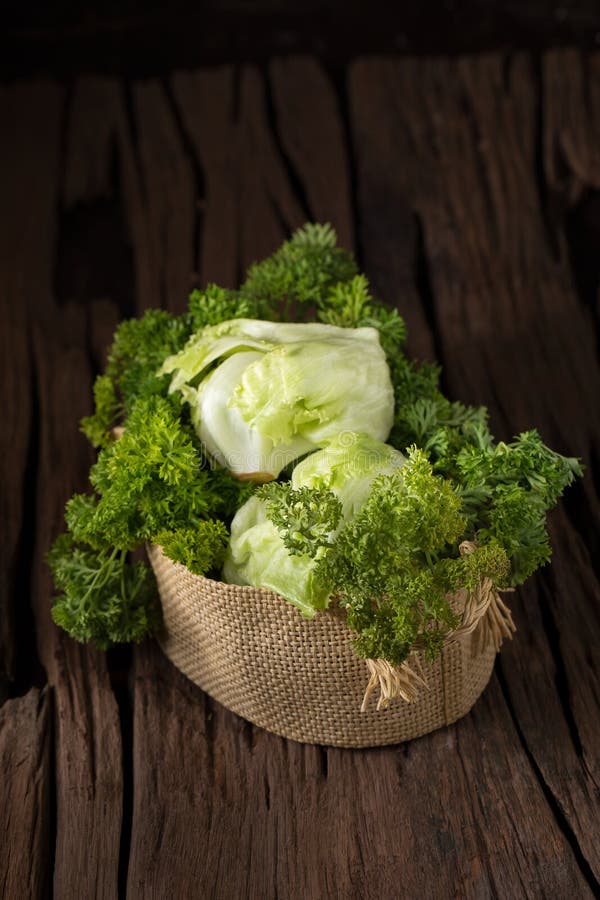 Vegetables in the basket on wooden background royalty free stock images