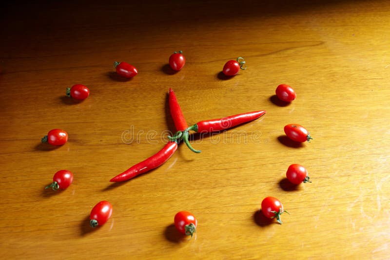 Vegetables clock on a wooden chopping board. Biological clock stock images, royalty-free photos and pictures