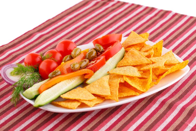 Vegetables, olives, nachos in plate