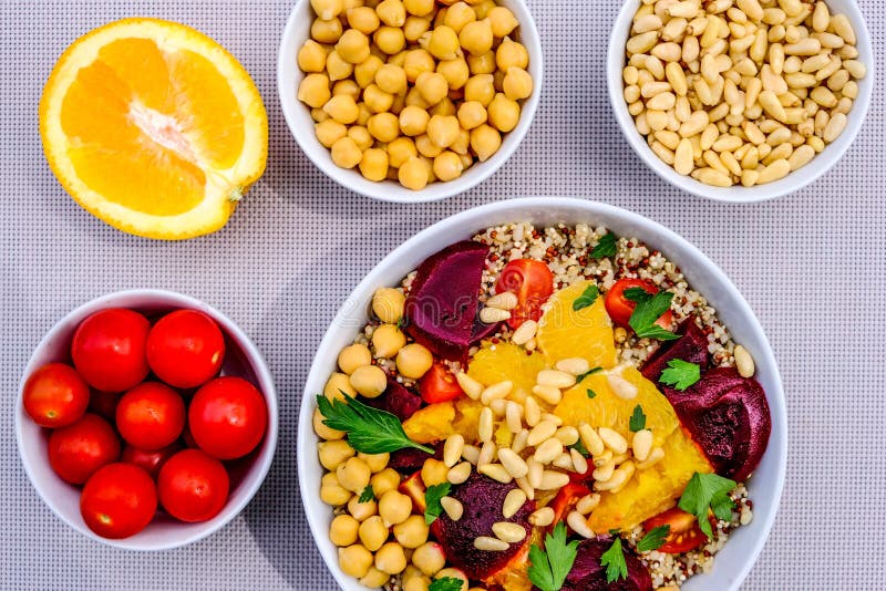 Vegetarian Bulgur Wheat and Quinoa Lunch Bowl With Orange Segments, chickpeas, Beetroot and Tomatoes