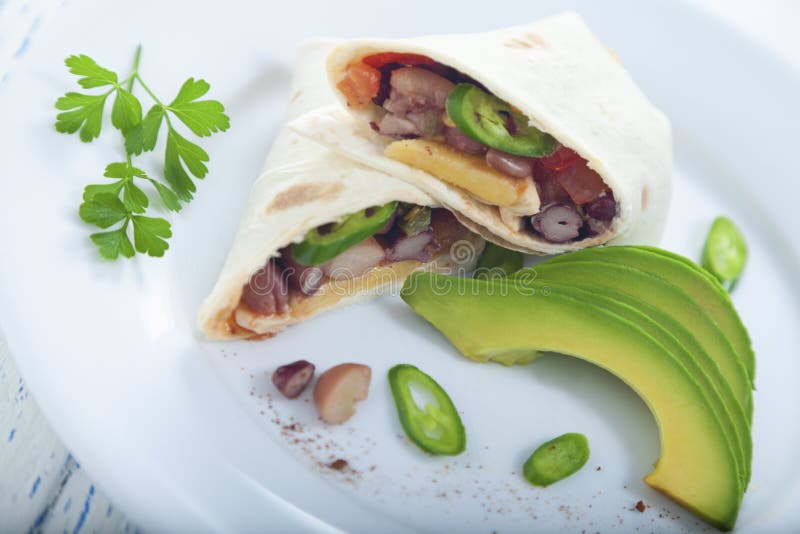 Burrito with Vegetarian Chili on a Plate with Lettuce and a Bowl of