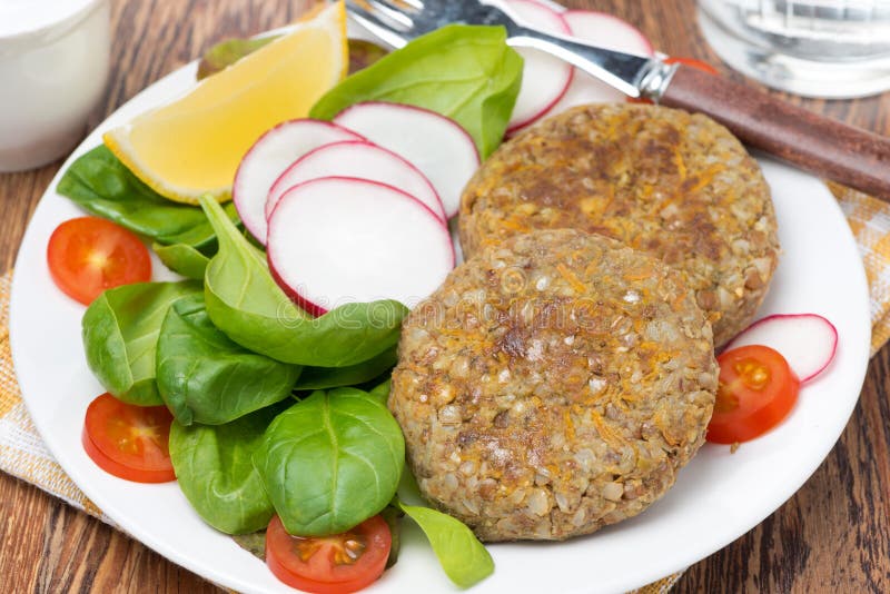 Vegetarian cutlets with fresh salad on the plate