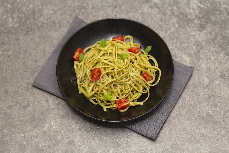 Vegetarian Pasta Spaghetti With Basil Pesto And Cherry Tomatoes. Stock
