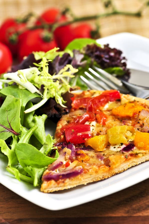 Vegetarian pizza with salad stock photos