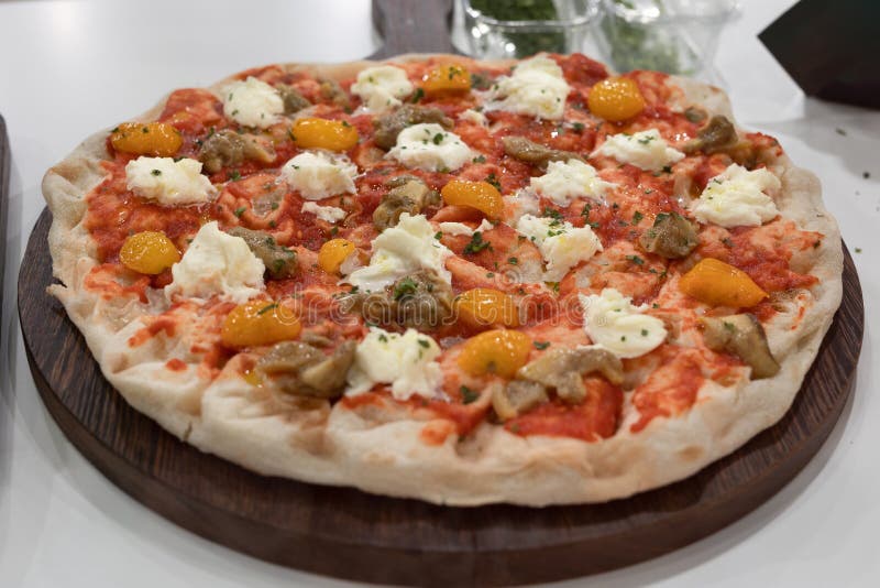 Vegetarian Pizza Stuffed with Basil, Tomatoes, Mushrooms and Cheese